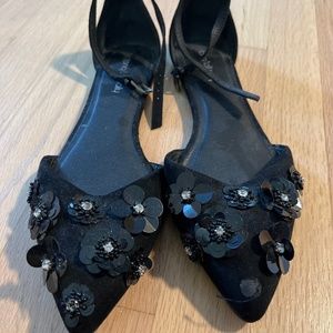 Black suede flats with flower detail